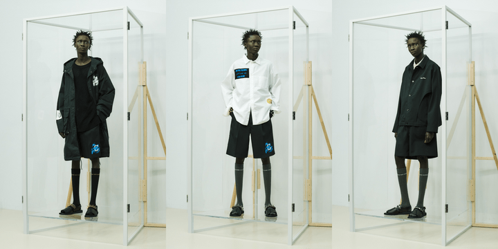 Undercover looks shown on models standing inside clear display boxes
