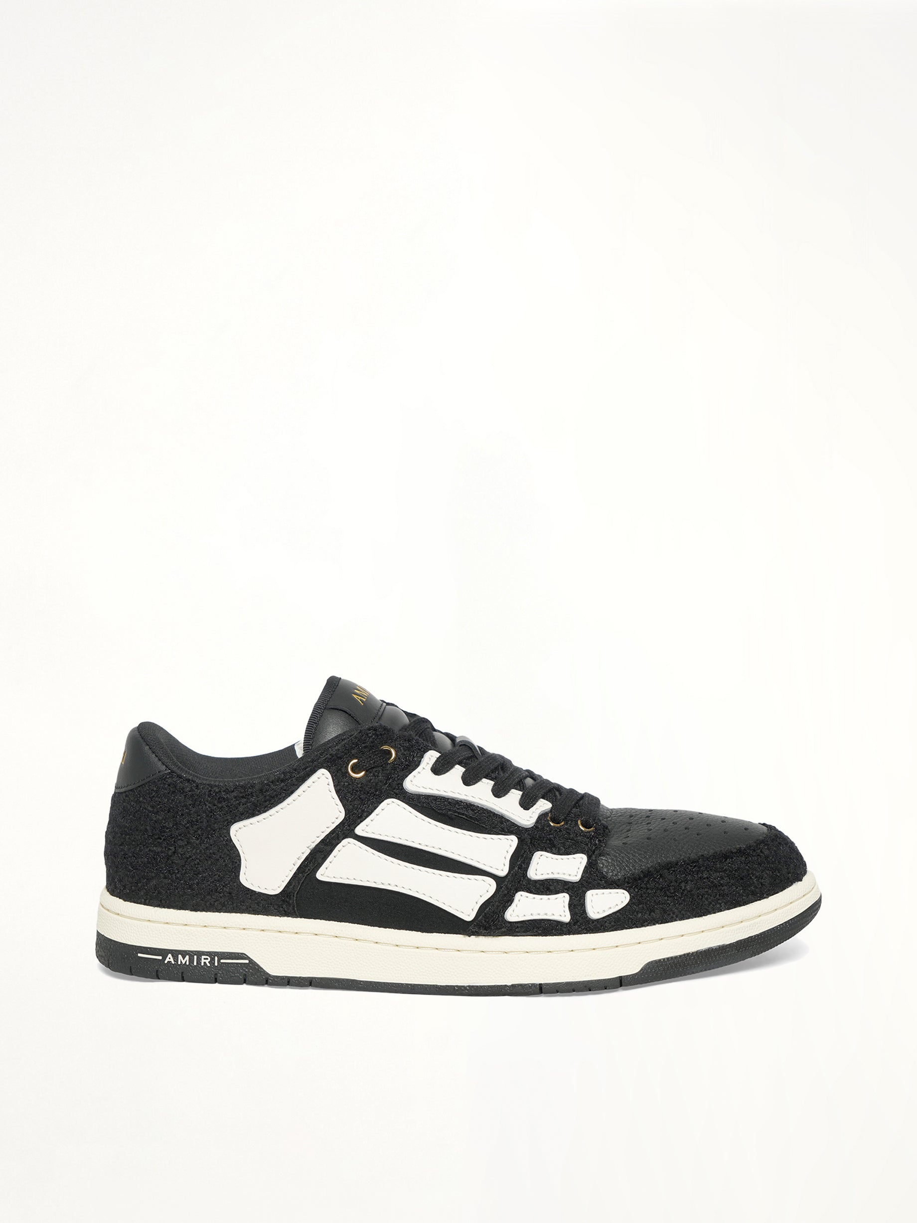 Boucle Skeleton Low Top Sneaker in Black Side View | AMIRI