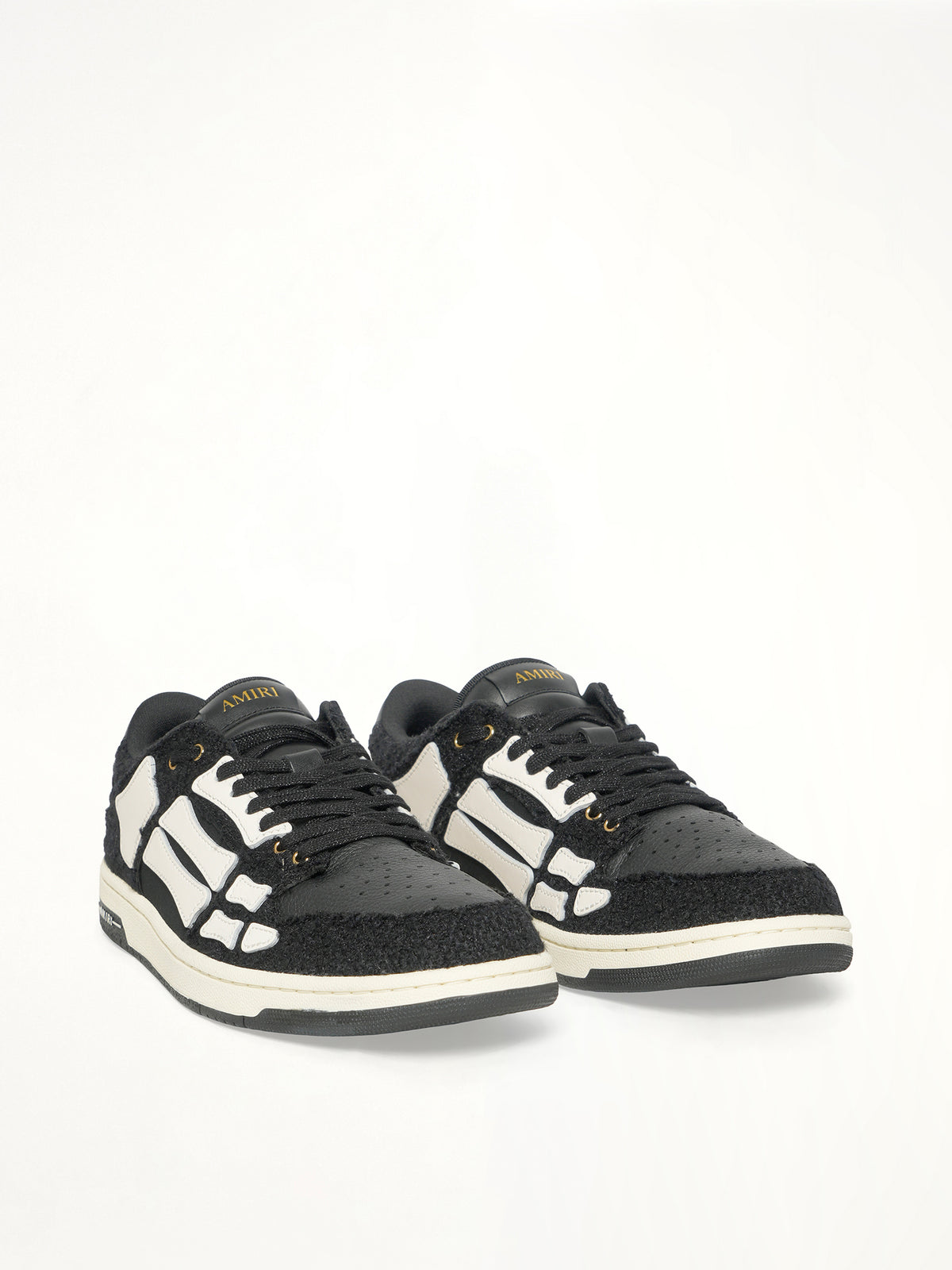 Boucle Skeleton Low Top Sneaker in Black Front View | AMIRI