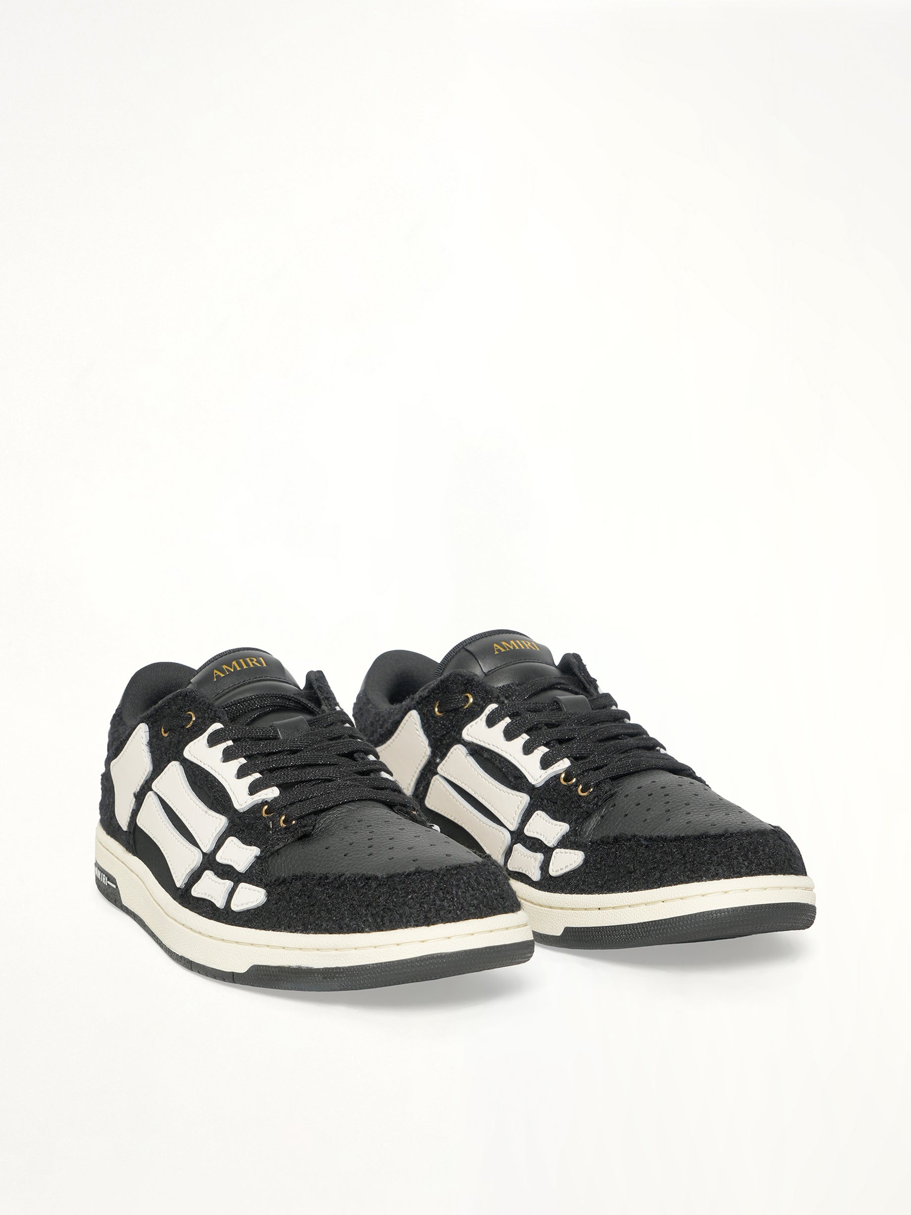 Boucle Skeleton Low Top Sneaker in Black Front View | AMIRI