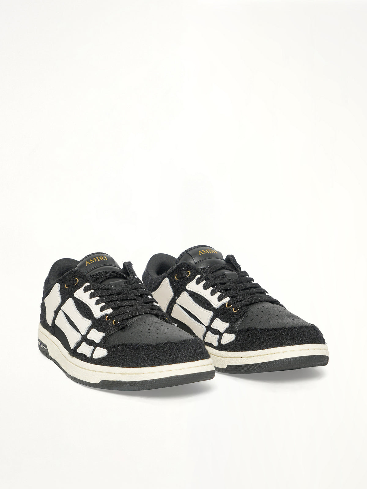 Boucle Skeleton Low Top Sneaker in Black Front View | AMIRI