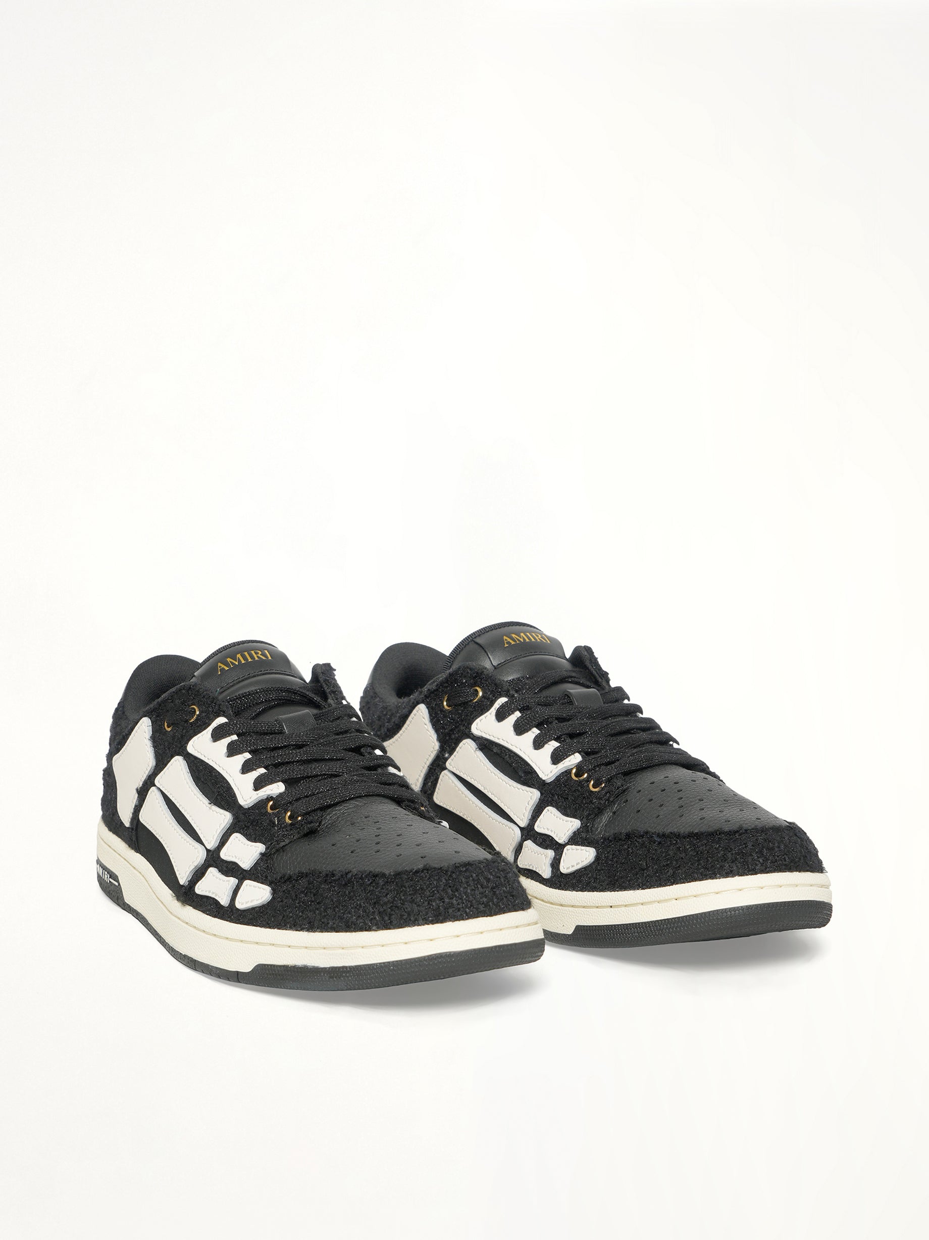 Boucle Skeleton Low Top Sneaker in Black Front View | AMIRI
