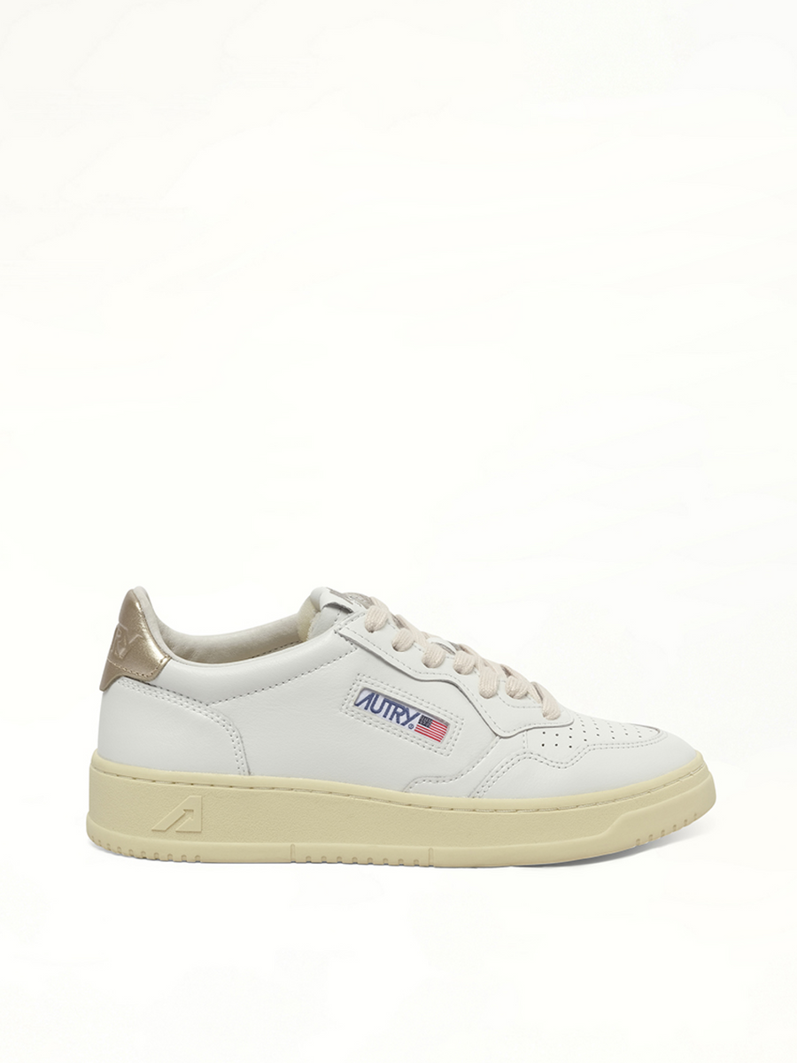Medalist Low Sneakers in White/Gold Side View | AUTRY