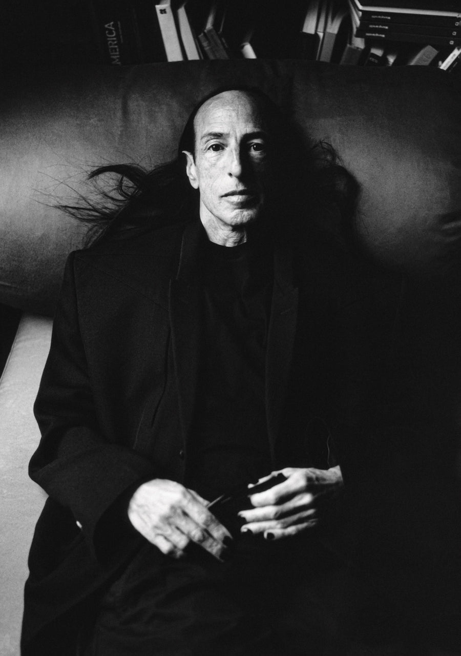 Black and white portrait of a man in black tailoring