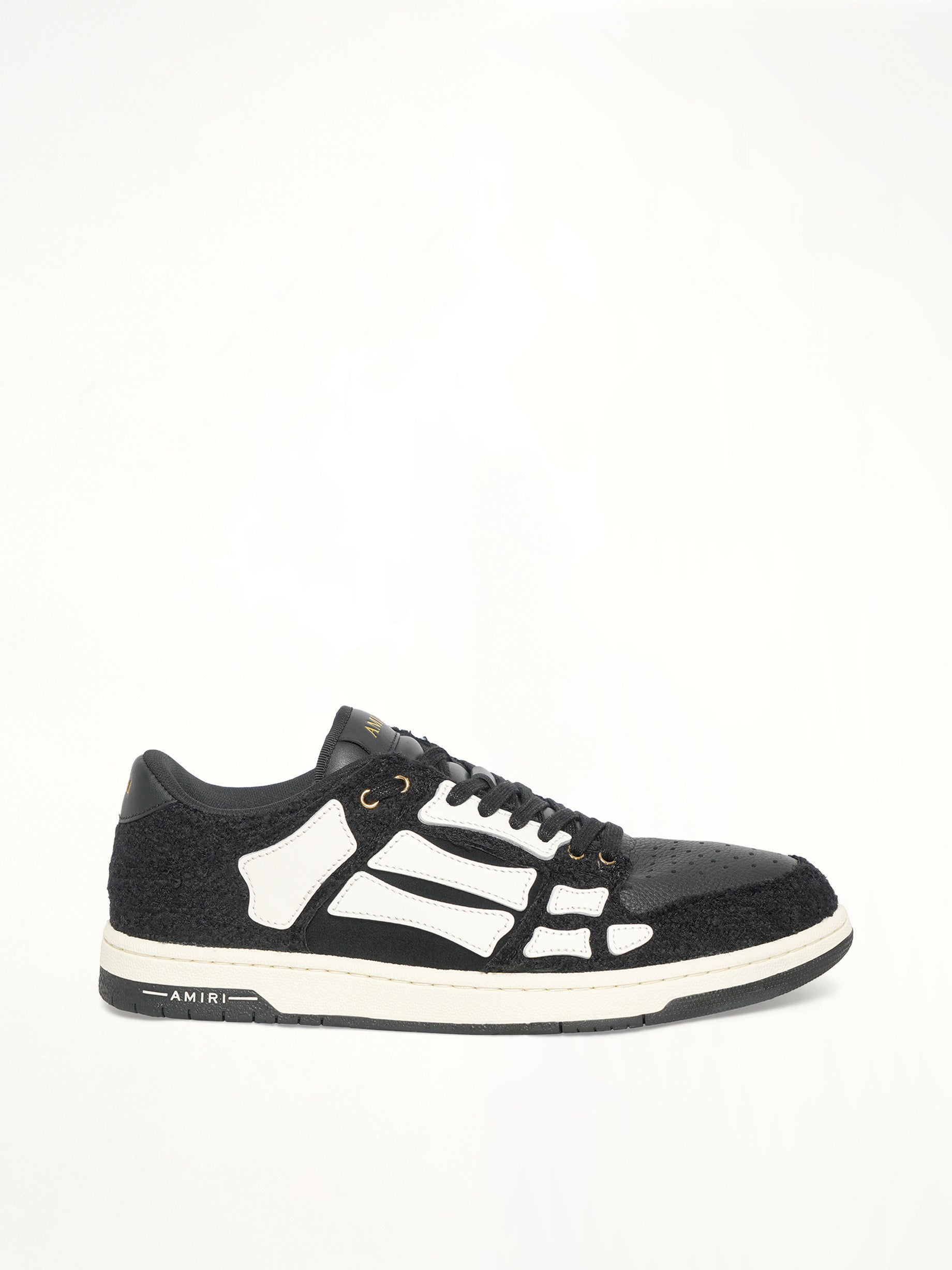 Boucle Skeleton Low Top Sneaker in Black Side View | AMIRI