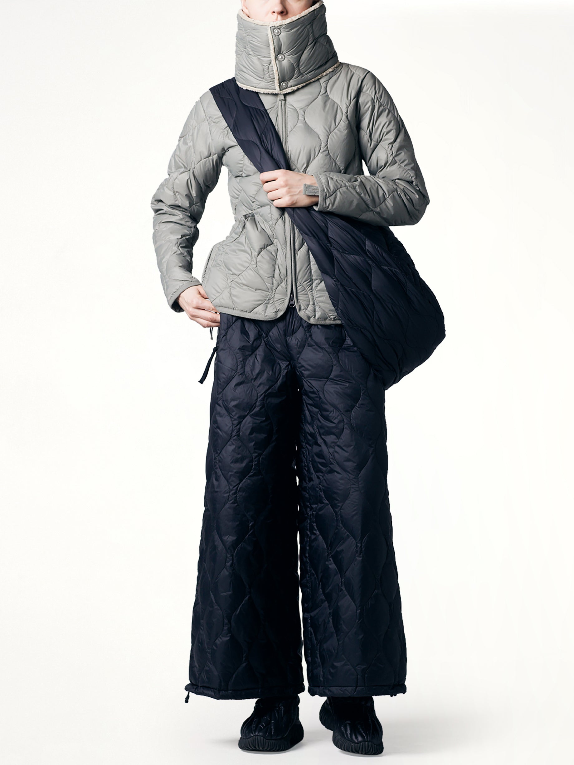 TAION Military Banana Shoulder Down Bag L in Black With Strap from MARAIS