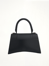 Hourglass Small Handbag in Box Calfskin in Black with Silver Plaque
