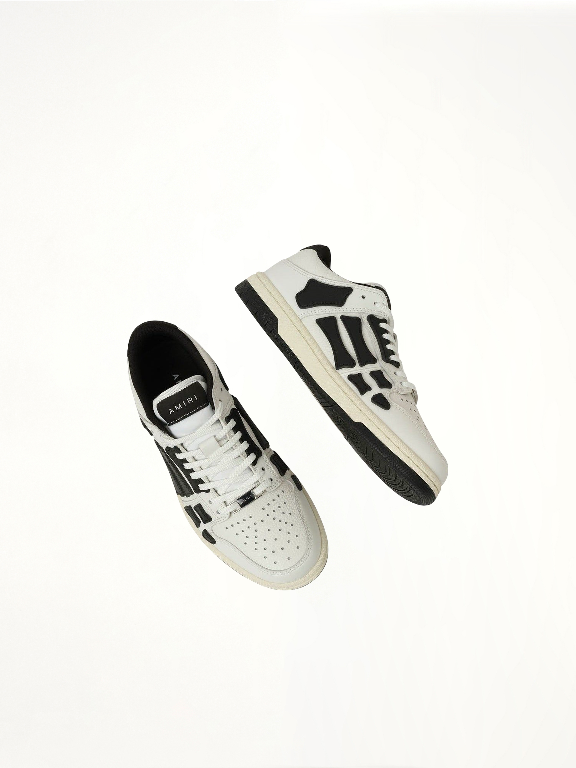 Skeleton Low Top Sneaker in White/Black Top View | AMIRI