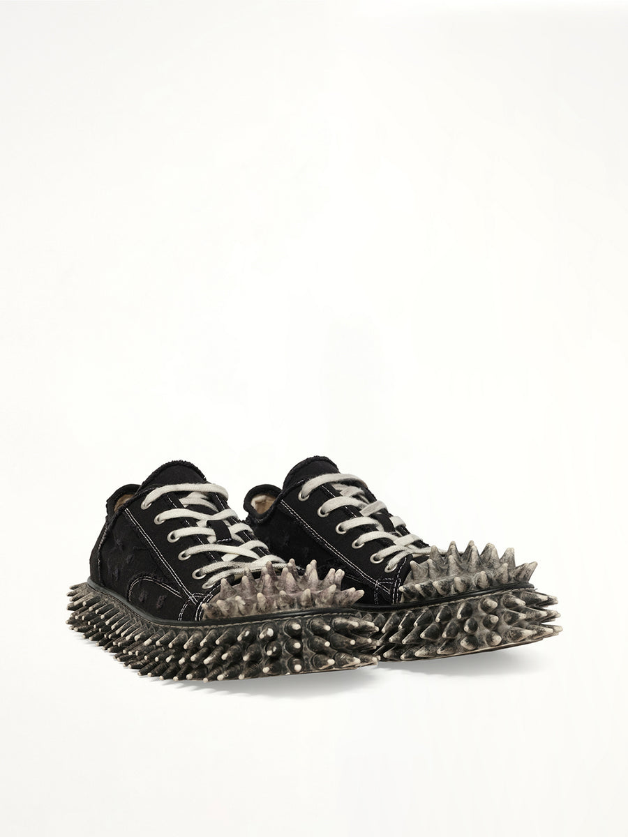 Dirty Spike Toe  Cap Canvas Sneaker in Black Front View | DOUBLET