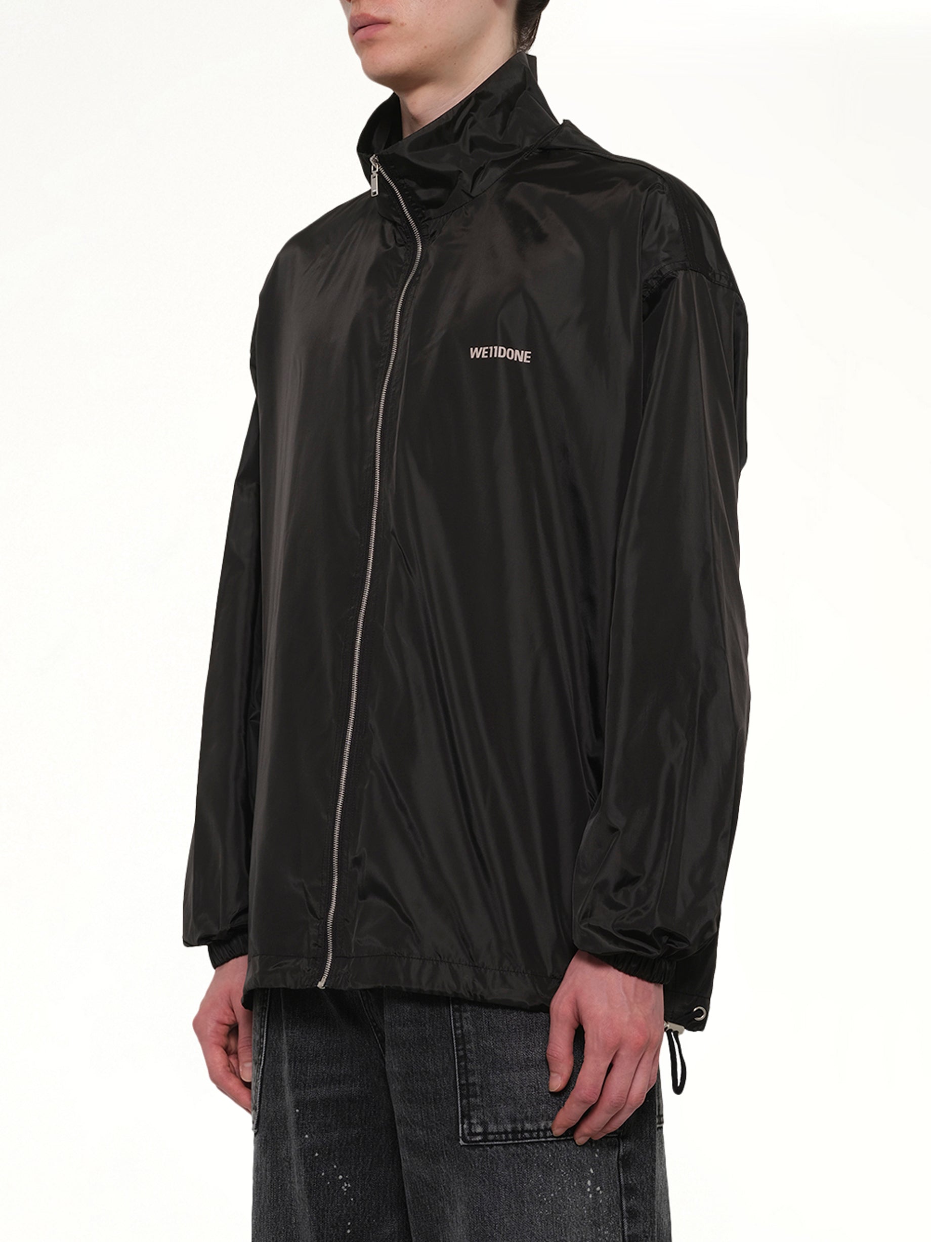 WE11DONE , Logo Windbreaker Jacket in Black Side View from MARAIS