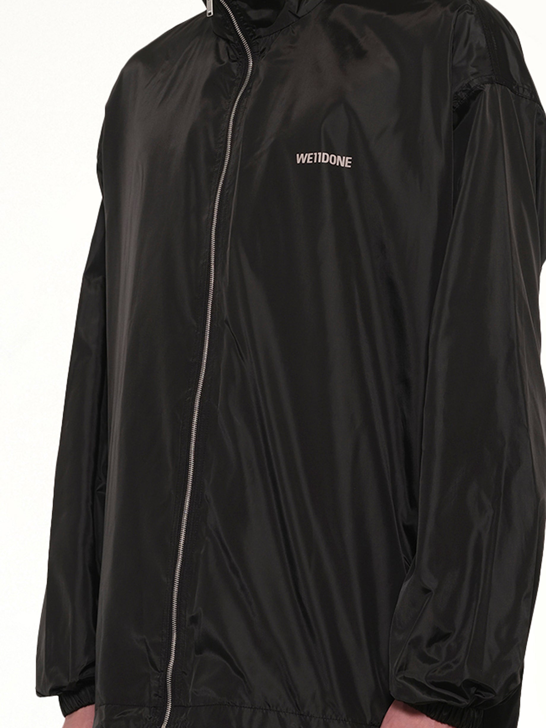 WE11DONE , Logo Windbreaker Jacket in Black Detail Shot from MARAIS