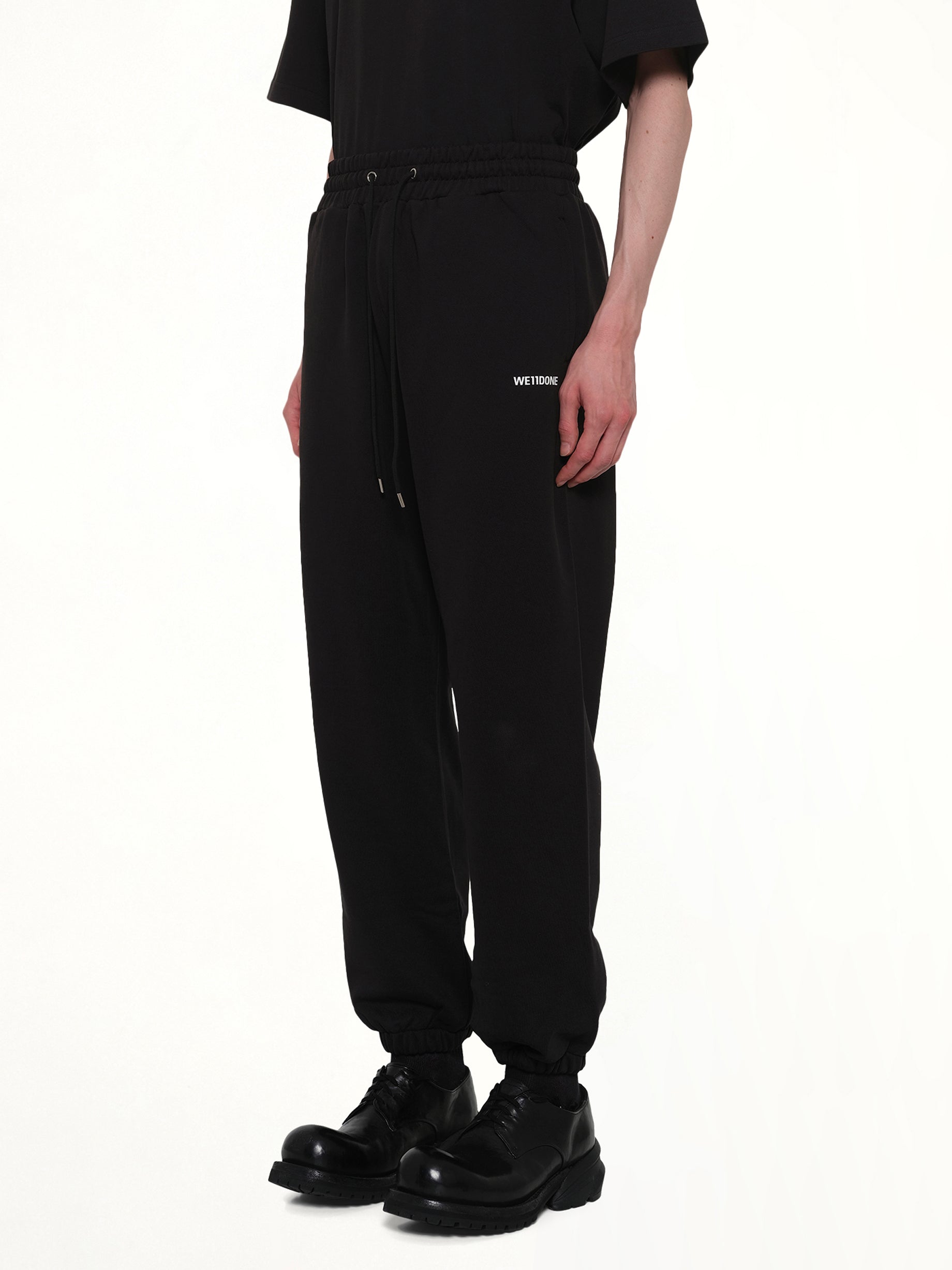 WE11DONE Logo Medium Lounge Pants in Black Side View from MARAIS
