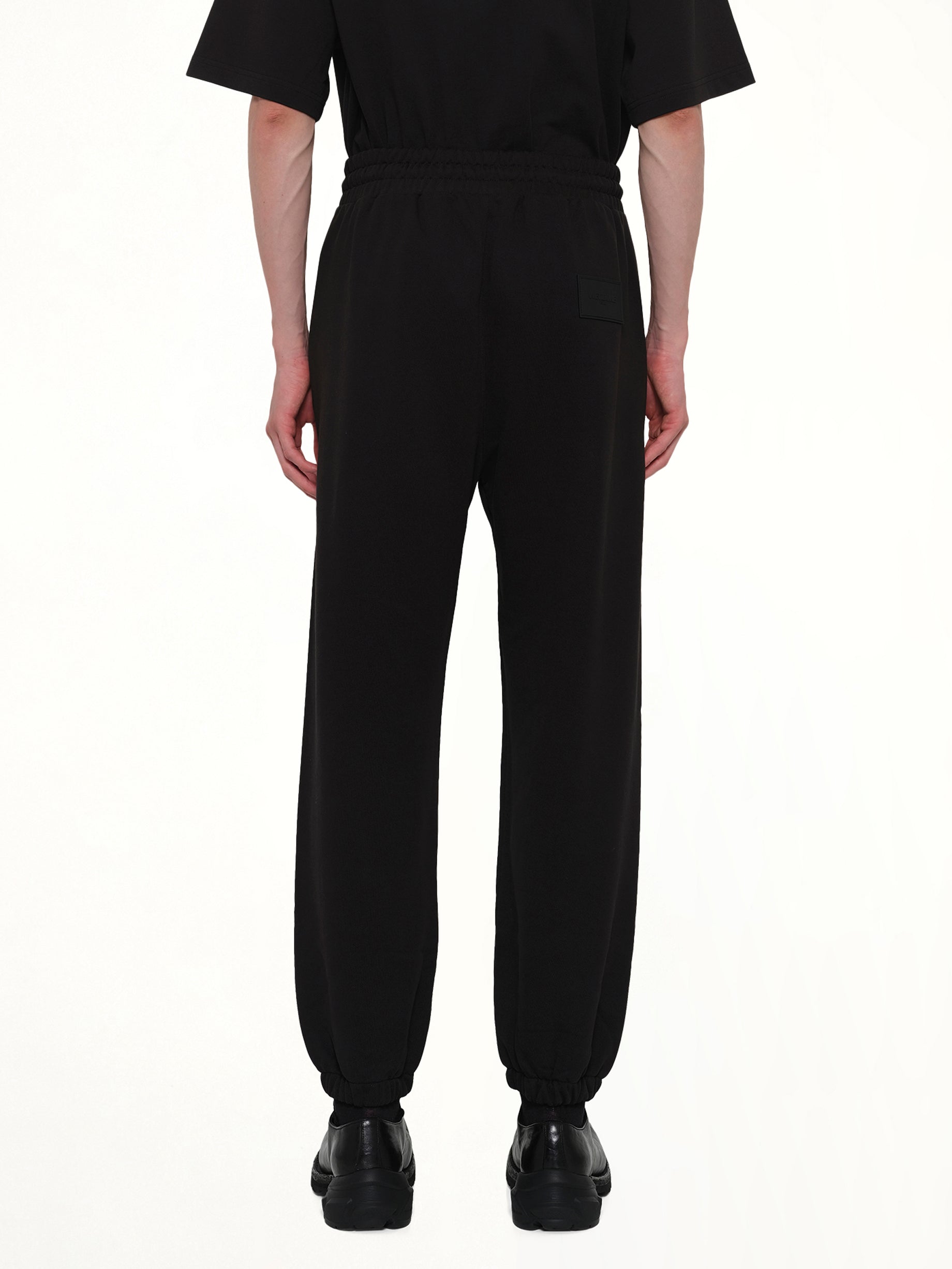 WE11DONE Logo Medium Lounge Pants in Black Back View from MARAIS