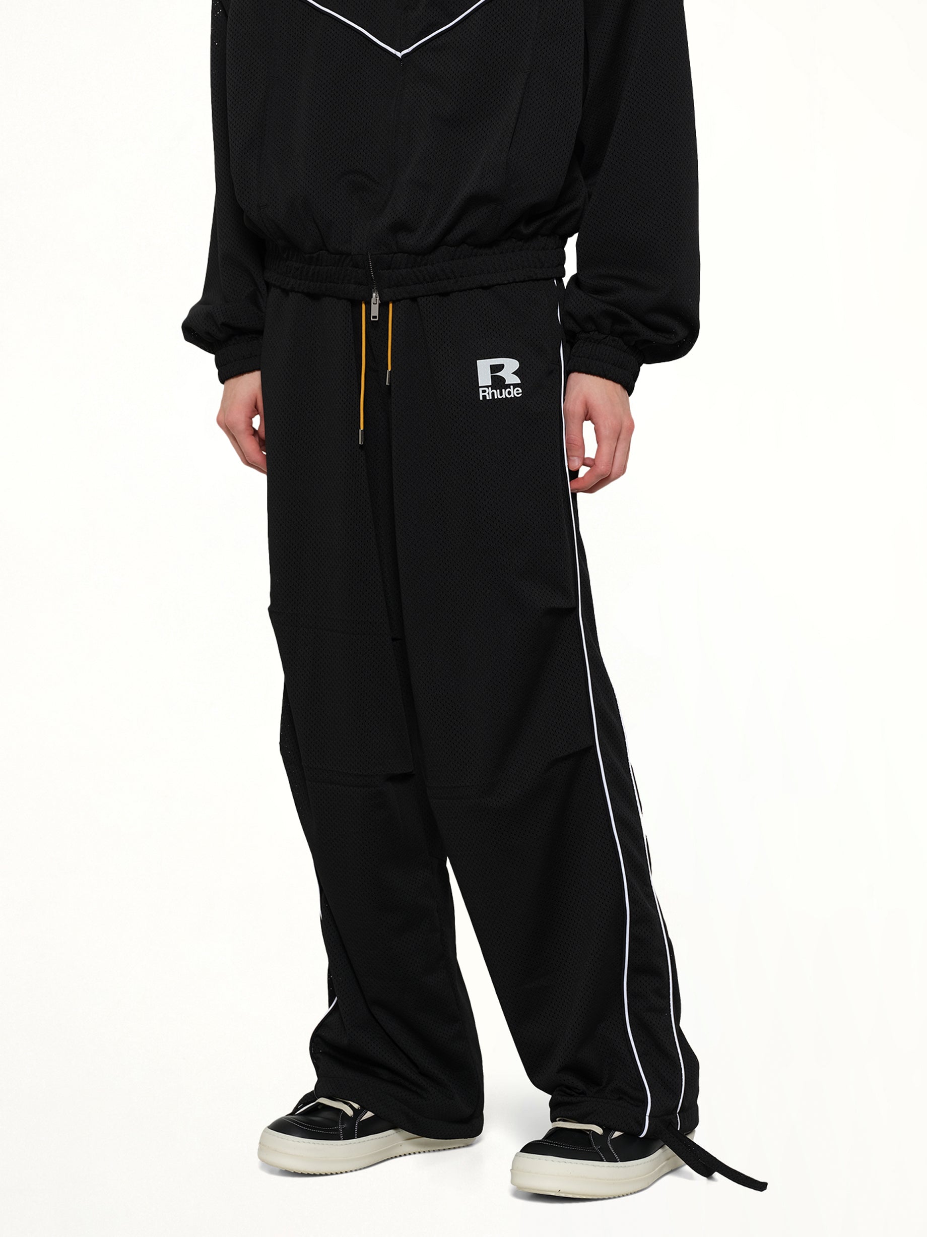 RHUDE Rhude Mesh Piping Parachute Track Pant in Black/White Detail Shot from MARAIS