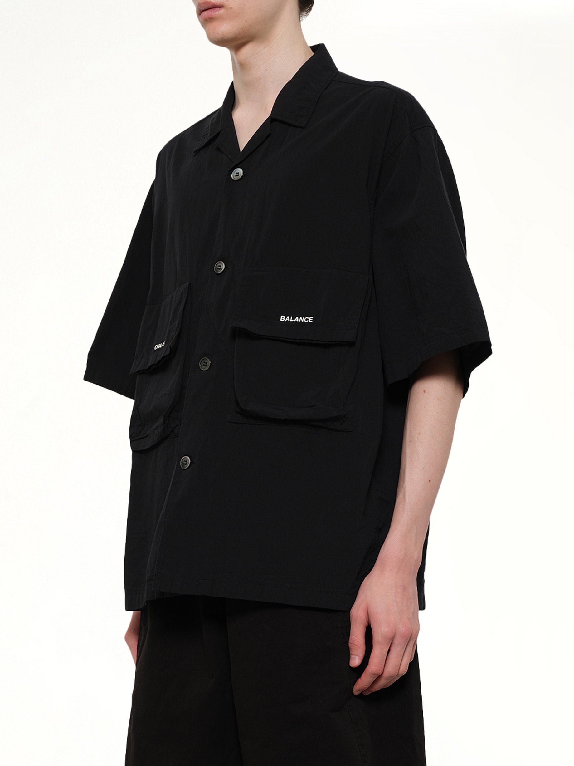 UNDERCOVER Chaos Balance Pocket Shirt in Black Side View from MARAIS