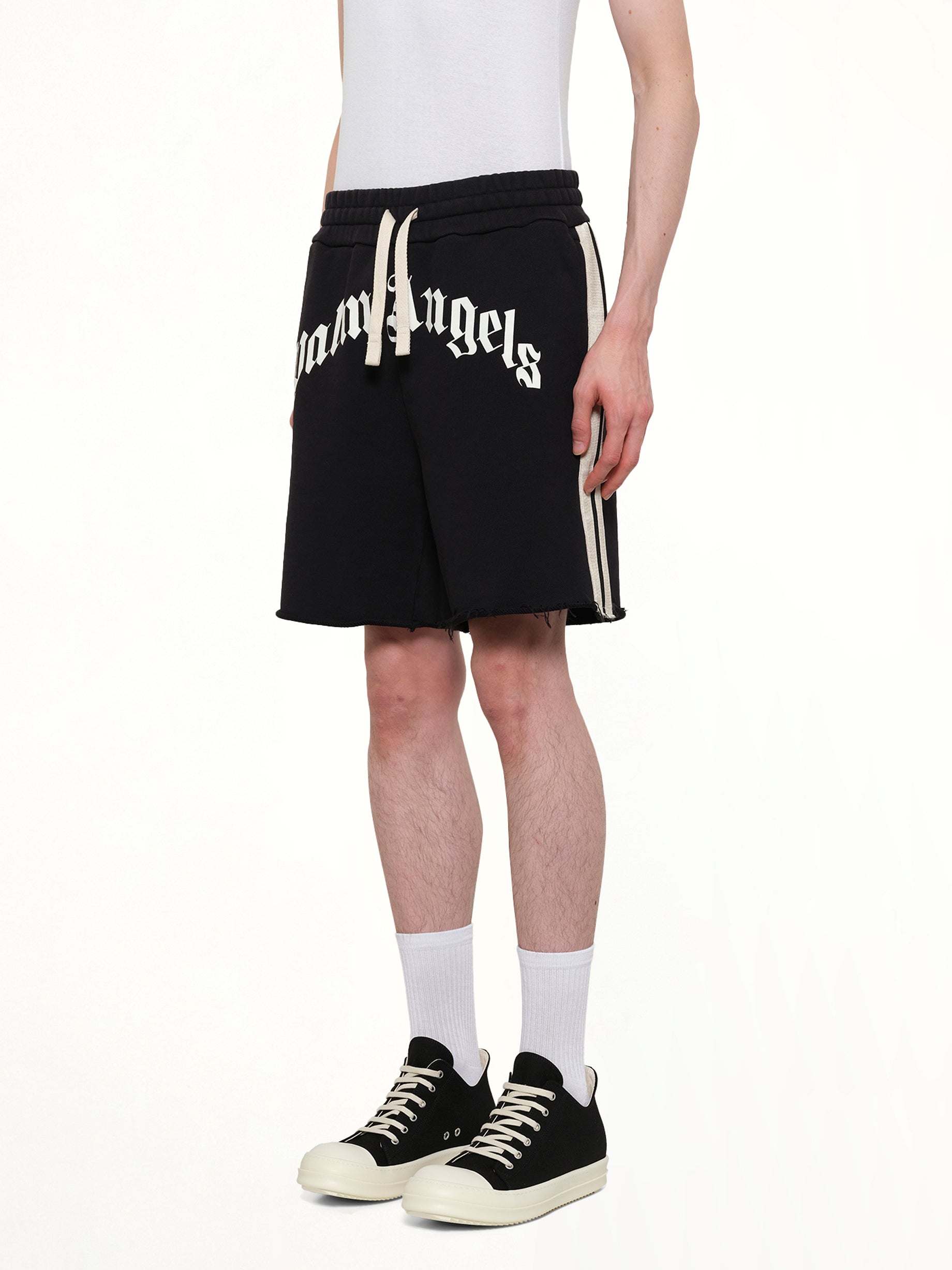 PALM ANGELS Curved Logo Track Sweatshorts in Black/Off White Side View from MARAIS