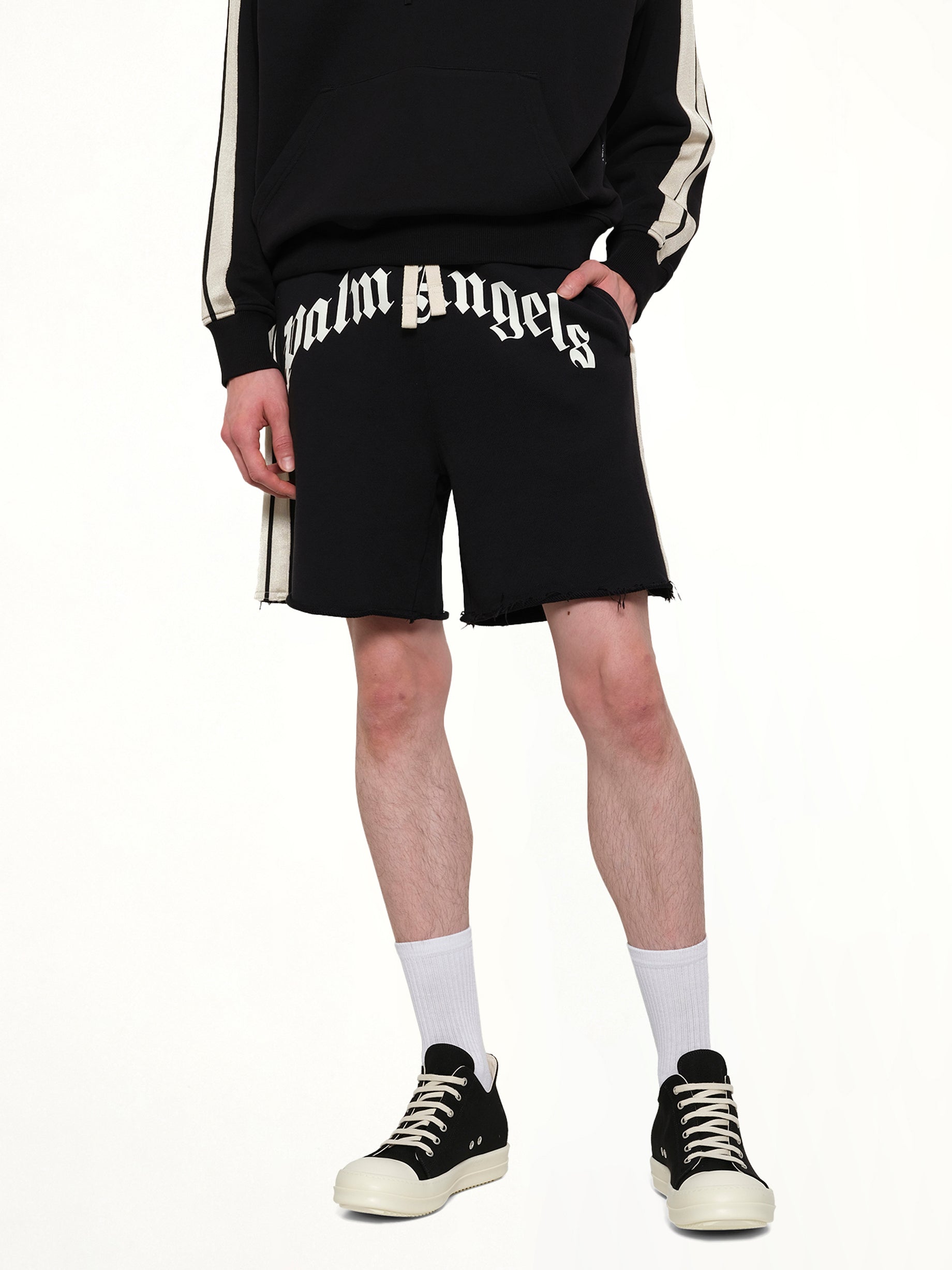 PALM ANGELS Curved Logo Track Sweatshorts in Black/Off White Detail Shot from MARAIS