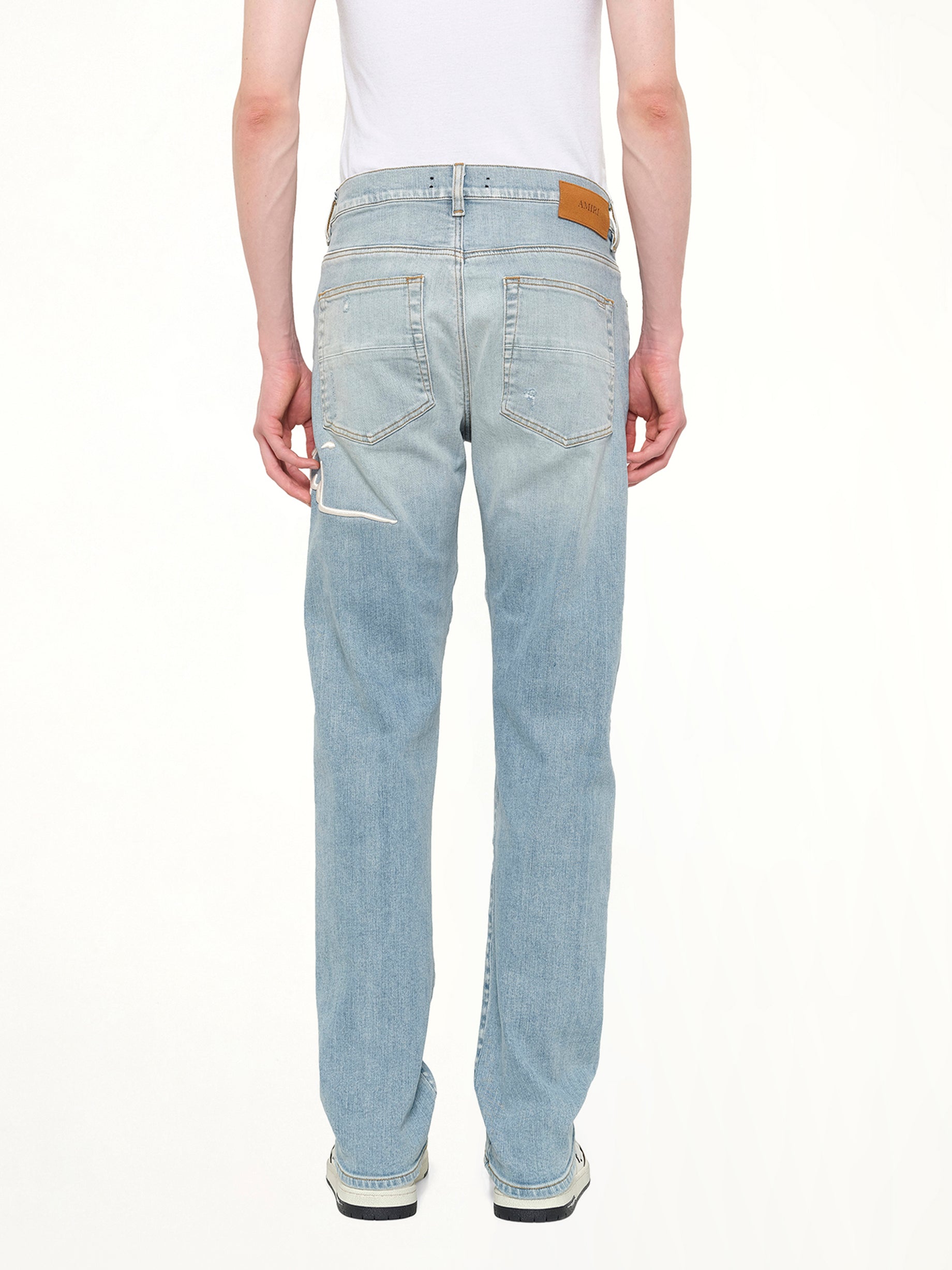 AMIRI Amiri Repaired Slim Jean in Worn Slate Back View from MARAIS