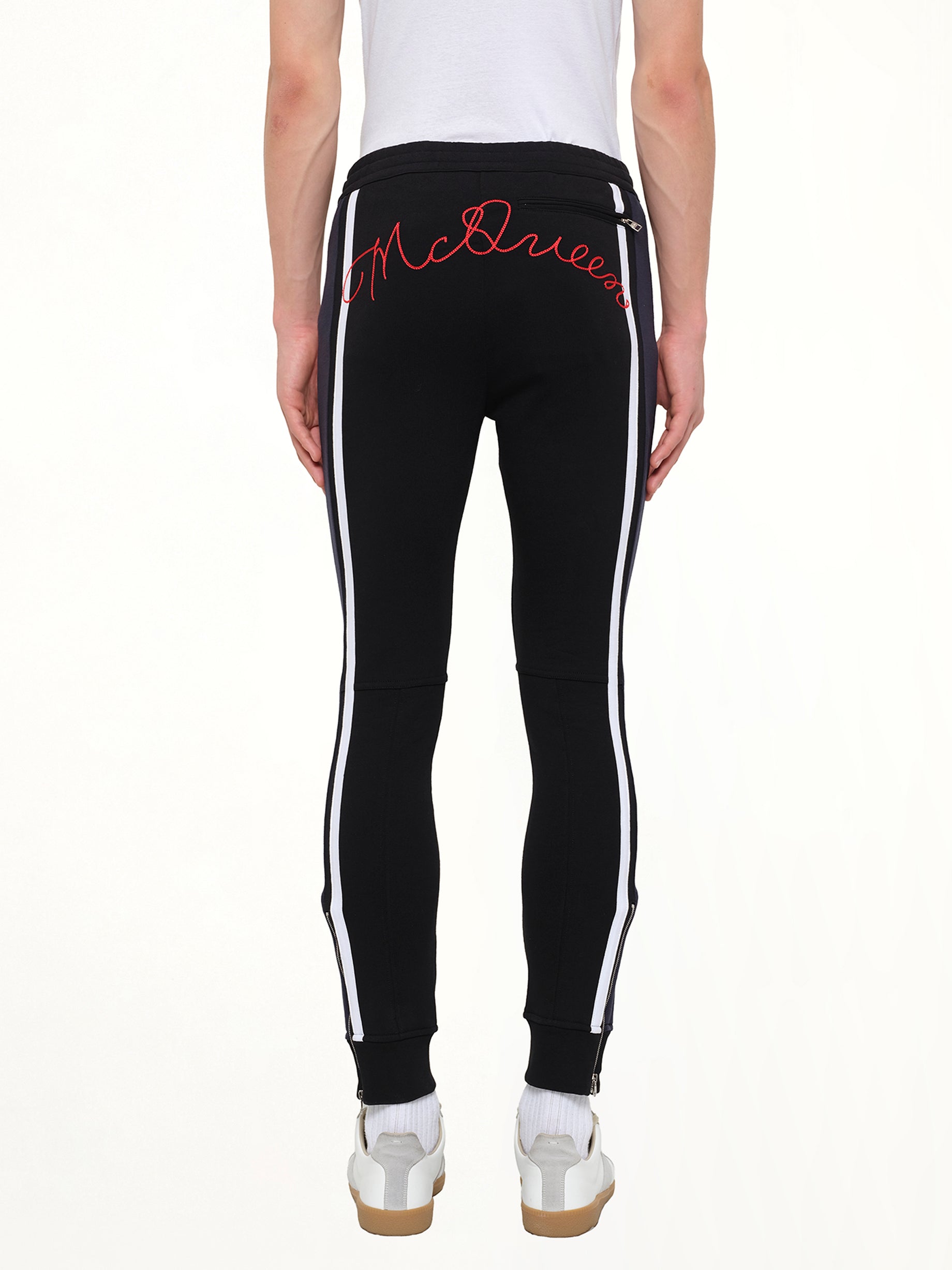 ALEXANDER MCQUEEN Embroidered Sweat Pants in Black Side View from MARAIS