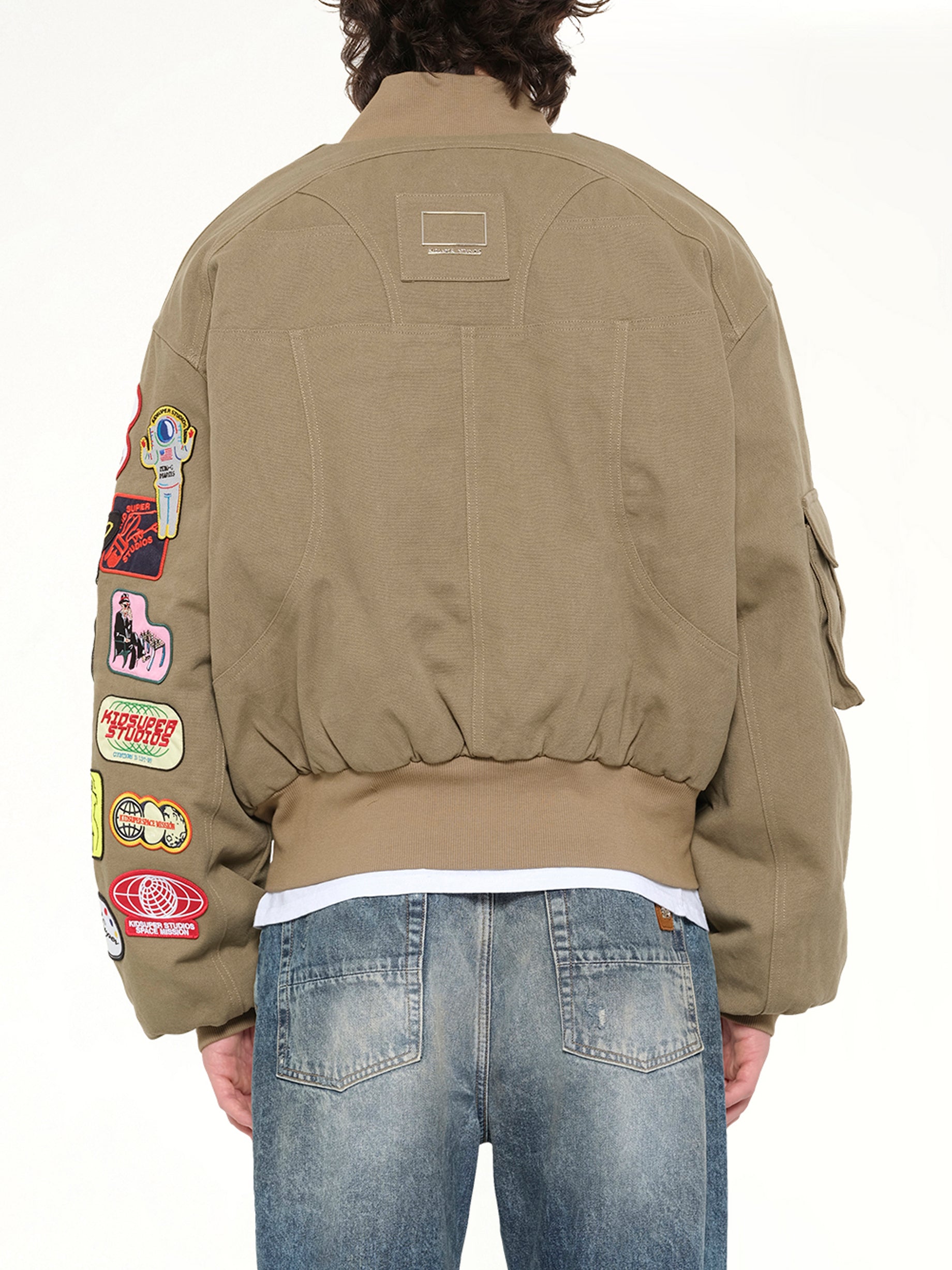 KIDSUPER Patches Bomber Jacket in Green Back View from MARAIS